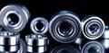 The image presents a workshop scene where several steel bearings are scattered on a reflective surface, with the Royalty Free Stock Photo