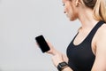 Image of pretty blond woman 20s dressed in sportswear using smartphone during workout in gym Royalty Free Stock Photo