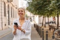 Image of pretty cheerful woman at the city with phone Royalty Free Stock Photo