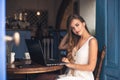 Image of pretty emotional happy girl sitting in cafe talking by mobile phone