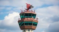 Close-up of an Airport Air Traffic Control Tower with Radar and Antennas Against a Cloudy Blue Sky Royalty Free Stock Photo