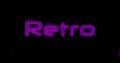 Image of purple letters of the Retro neon sign with two purple explosions on black background 4k Royalty Free Stock Photo