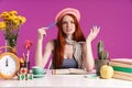 Image of puzzled teenage girl studying with exercise books while sitting at desk Royalty Free Stock Photo