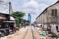 Image of rail train crossing shanty town in Phnom Penh.