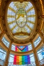 Rainbow flag dangling from Rotunda Roof interior view with stained glass ceiling