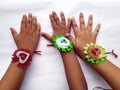 RAKHI in children hand FOR RAKHA BHANDHAN INDIAN FESTIVAL