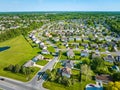 Red cars on neighborhood streets aerial with lots of houses