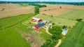 Red stables and red barn aerial with farmhouse and fields and a pasture with cows Royalty Free Stock Photo