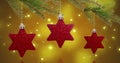 Image of red star baubles over snow falling background Royalty Free Stock Photo