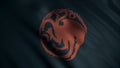 Image of red three-headed dragon twisted into circle on background of developing black flag. Animation. Emblem of house