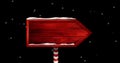 Image of red wooden sign with copy space and snow falling over black background Royalty Free Stock Photo