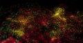 Image of red, yellow and blue particle cloud moving on black background