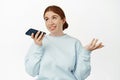 Image of redhead caucasian girl record voice message, talking on speakerphone, gesturing and chatting on mobile app