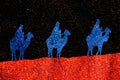 The three wise men from the east ride their camels to Bethlehem on a starry night Royalty Free Stock Photo