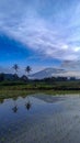 image of reflection trees and Mount Marapi in Padang Panjang City, West Sumatra, Indonesia Royalty Free Stock Photo