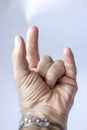 Image that represents a palm upward hand with the typical gesture of the spider man or that you want the gesture of making the hor Royalty Free Stock Photo