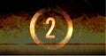 Image of ring and glowing number two in dramatic countdown over flaming fire background