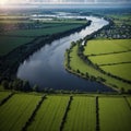 River Shannon flows between green grass fields and agriculture land. Irish landscape. Low cloudy sky. Aerial