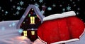 Image of road sign with copy space and snow falling over house at christmas and winter landscape Royalty Free Stock Photo
