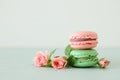 Image of romantic colorful macaron or macaroon over pastel background.