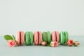 Image of romantic colorful macaron or macaroon over pastel background.