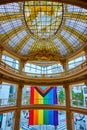 Rotunda ceiling rainbow flag dangling below upper balcony outside window Royalty Free Stock Photo