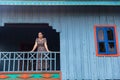 Image of rural countryside in Cambodia. Blue traditional house. Wooden hut. Beautiful khmer woman.