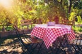 Image of rural restaurant with vintage table and chairs outdoors.
