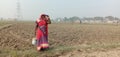 It is an image of rural woman who works in the field of India
