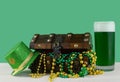Image for Saint Patrick`s Day on March 17th. Treasure chest to symbolize luck and wealth with a glass of green beer.