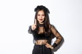 Image of sassy young beautiful asian woman in black gothic dress and party makeup, dressed-up for halloween trick or Royalty Free Stock Photo