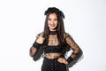 Image of satisfied pretty asian girl in halloween costume showing thumbs-up in approval, smiling pleased. Woman in evil