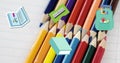 Image of schoolbag and school equipment moving over coloured pencils on notebook Royalty Free Stock Photo