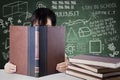 Schoolgirl reads a book with scribbles background Royalty Free Stock Photo