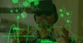 Image of scientific data in green floating in the foreground with a young mixed race man wearing a V Royalty Free Stock Photo