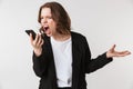 Screaming agressive young woman standing isolated