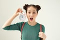 Image of screaming young confused woman standing isolated over white background. Looking aside holding alarm clock Royalty Free Stock Photo