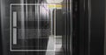 Image of screens with programming language moving over data server racks Royalty Free Stock Photo