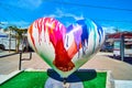 Sculpture in Castro District of heart with people holding hands on bright sunny day