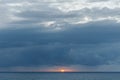 Image of sea, red sun, cloudy sky Royalty Free Stock Photo