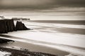 a seasonal snow covered view of atlantic ocean and ballybunion castle beach and cliffs on a frosty snow