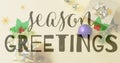 Image of seasons greetings text over christmas decorations Royalty Free Stock Photo