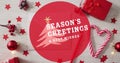 Image of seasons greetings text over christmas decorations Royalty Free Stock Photo
