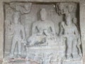 Image of a seated Buddha in teaching Dharmacakra pose, flanked by Bodhisattvas Vajrapani & Padmapani, Aurangabad Cave 1, India
