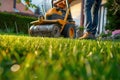 Spring Garden Maintenance: Worker Operating Lawn Mower Royalty Free Stock Photo