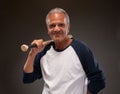 Image of a senior adult man posing with baseball bat