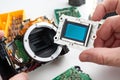 Image sensor digital SLR camera in hands of service engineer