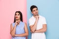 Image of serious man and woman in casual wear touching chins and Royalty Free Stock Photo