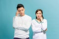 Image of serious thinking young loving couple isolated over light blue wall background looking aside Royalty Free Stock Photo