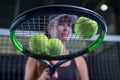 Image of a set of tennis balls lying on the strings of a racket. Sports concept Royalty Free Stock Photo